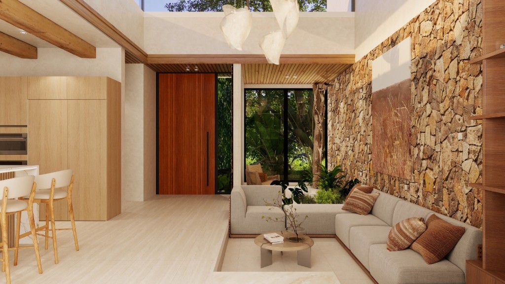 Open living space with kitchen, sunken lounge and stone feature wall at Casa Colinas